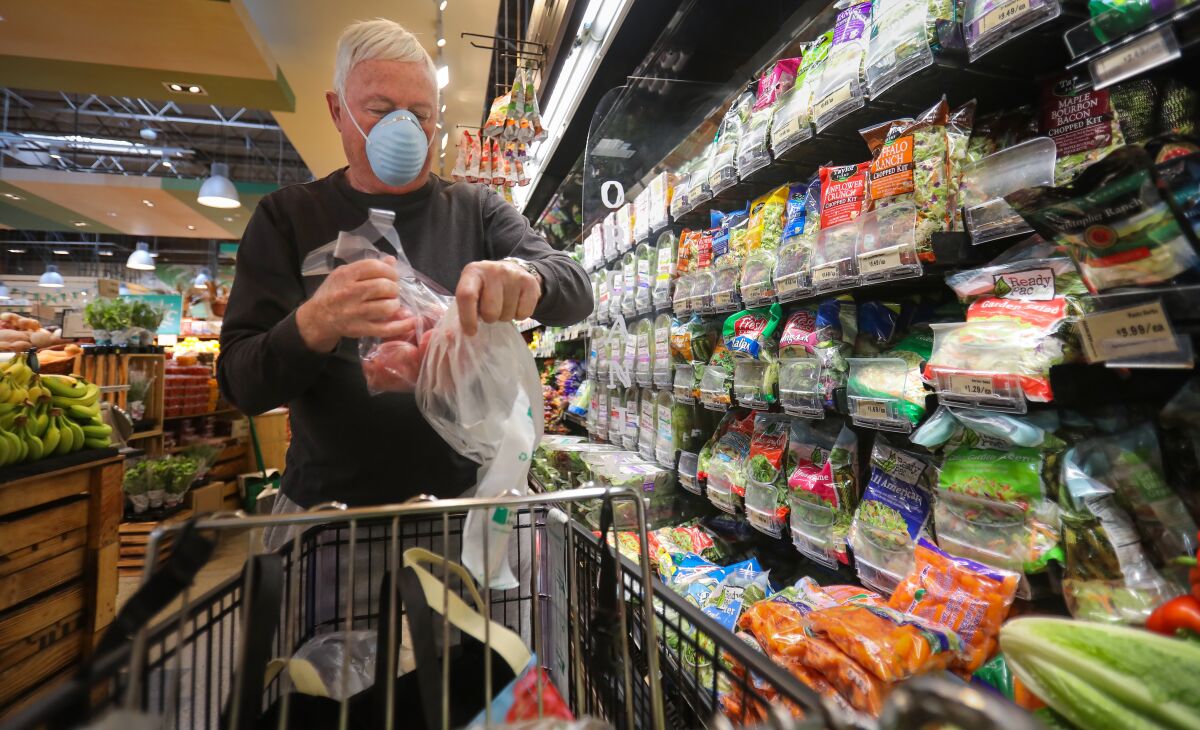 Chuck Pennell of Bankers Hill, wearing a face mask, at Barons Market in North Park during a seniors-only hour.