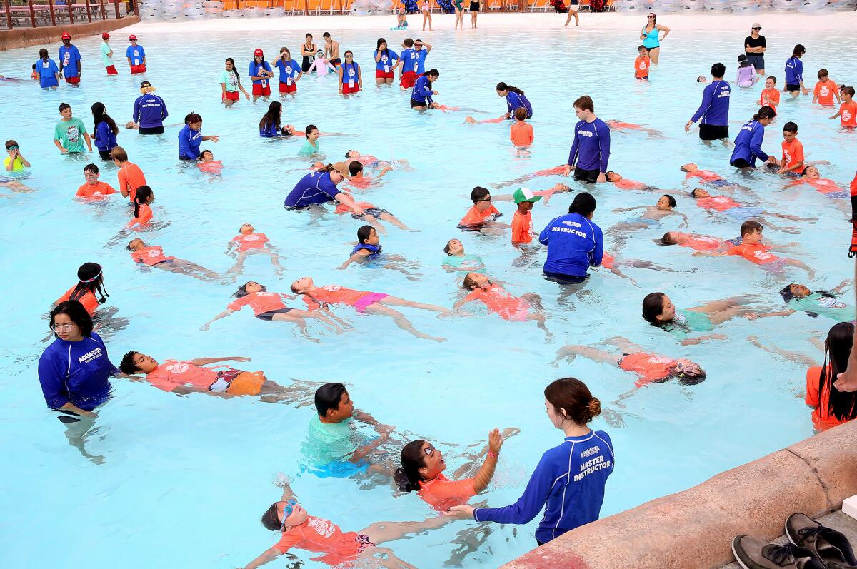 Kids learn to float on their backs at Wild Rivers Waterpark in Irvine.