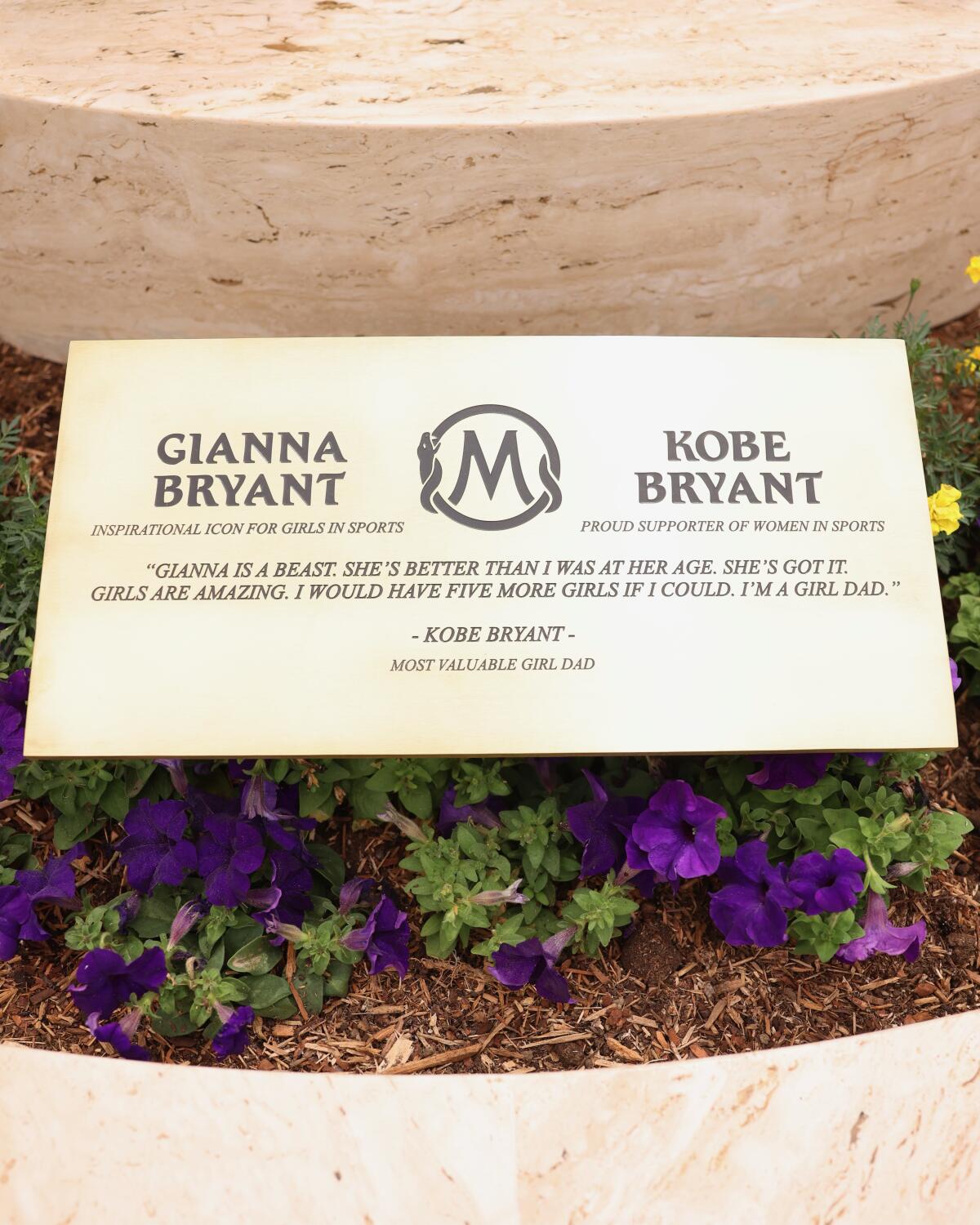 A plaque in front of a statue featuring Kobe and Gianna Bryant honors his commitment to being a "Girl Dad"