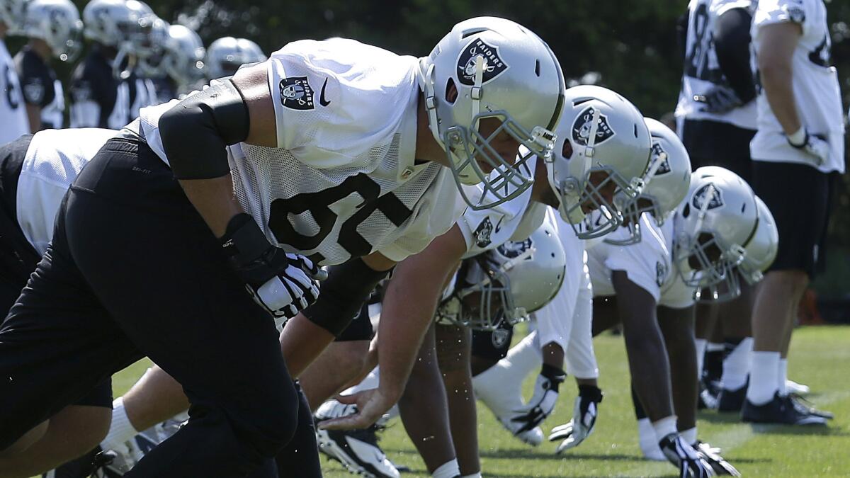 Oakland Raiders players run a drill during rookie minicamp May 8 in Alameda.