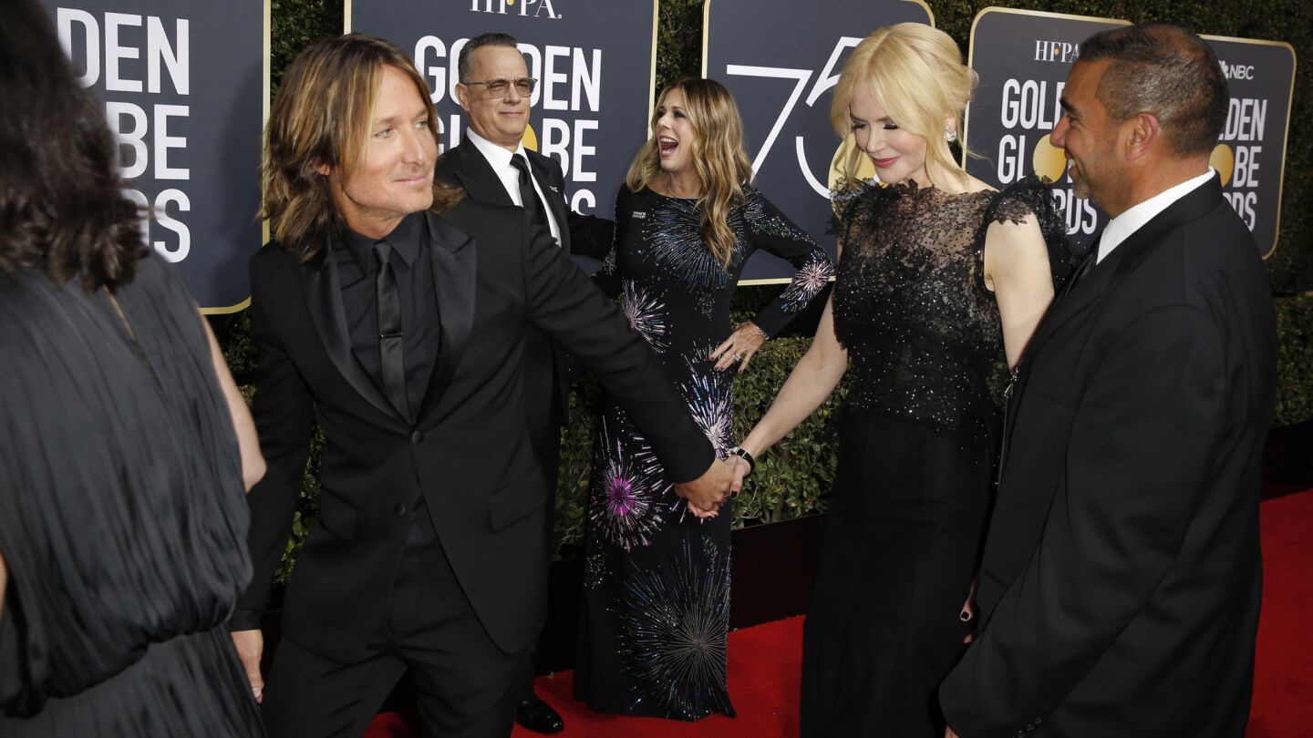 Tom Hanks and Rita Wilson watch as Keith Urban and Nicole Kidman arrive for the 75th Golden Globe Awards.