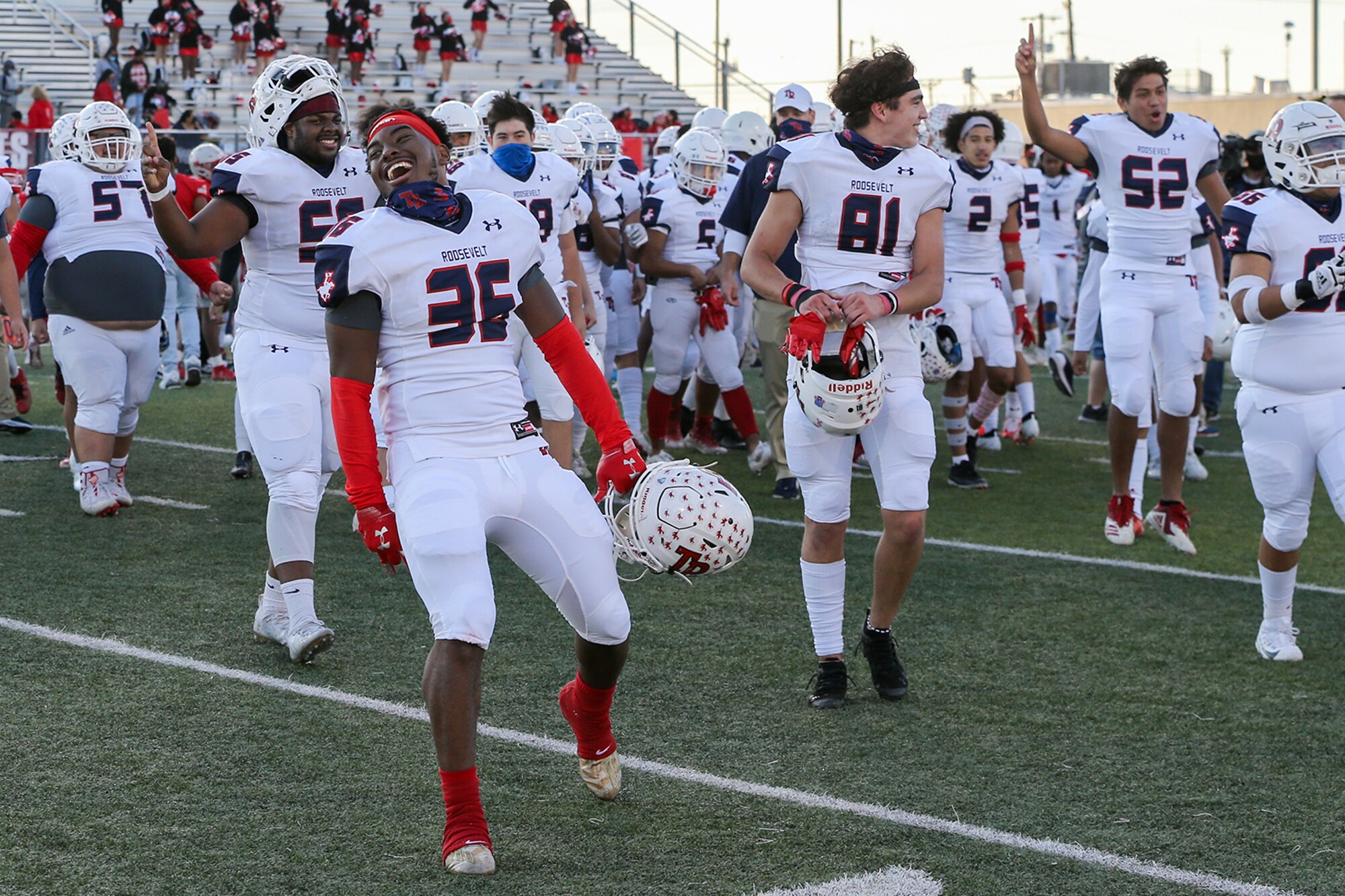 Maleek Chambers and the rest of the Roosevelt Rough Riders celebrate on the field.