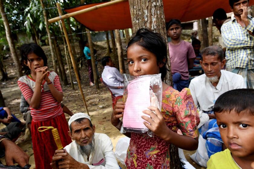 AUSTRALIA AND NEW ZEALAND OUT Mandatory Credit: Photo by Tracey Nearmy/EPA-EFE/REX/Shutterstock (9296826b) Rohingya children wait for their parents to receive aid at the Balukhali food distribution centre near Cox's Bazar in Bangladesh, 19 December 2017. More than 646,000 Rohingya refugees have crossed the border from Myanmar into Bangladesh following the Myanmar army's August crackdown on Rohingya rebels in the state of Rakhine state. Traveling with assistance from Save the Children. Rohingya refugees, Cox's Bazar, Bangladesh - 19 Dec 2017 ** Usable by LA, CT and MoD ONLY **