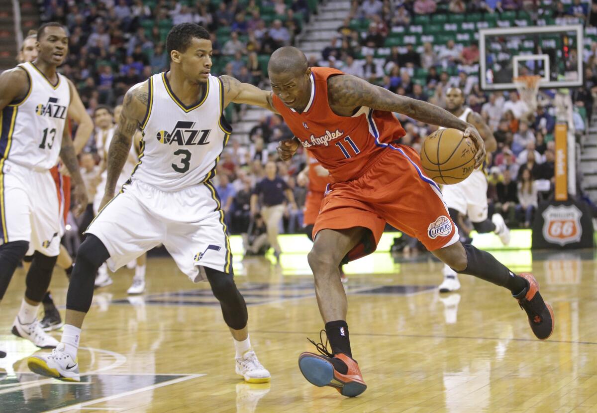 Clippers guard Jamal Crawford, right, drives to the basket as Utah guard Trey Burke defends.