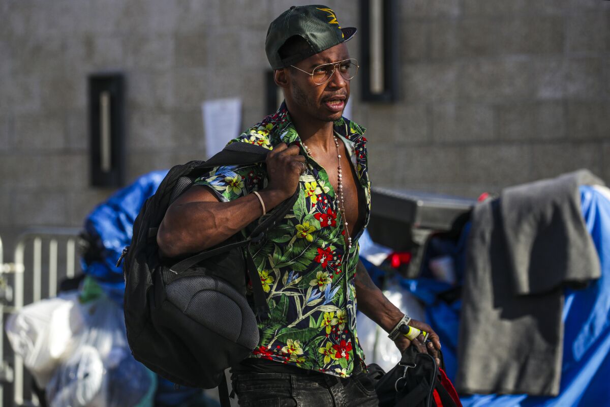 Tommy Miller leaves a homeless encampment.