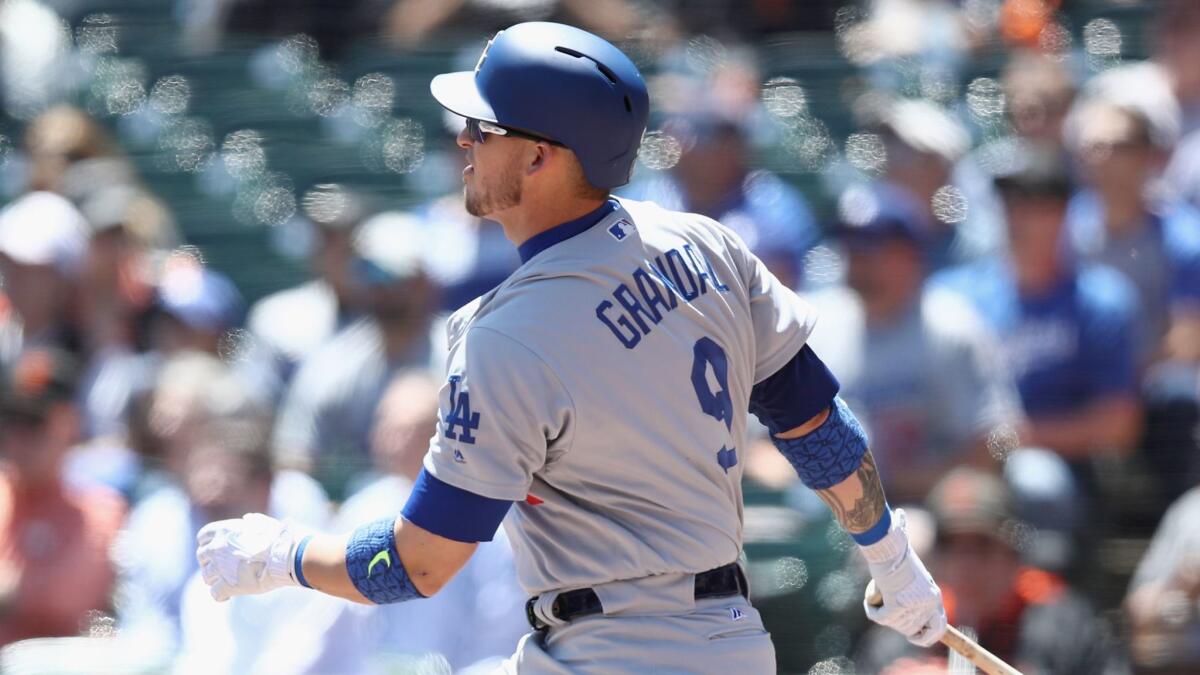 Dodgers catcher Yasmani Grandal hits a two-run double against San Francisco on May 17.