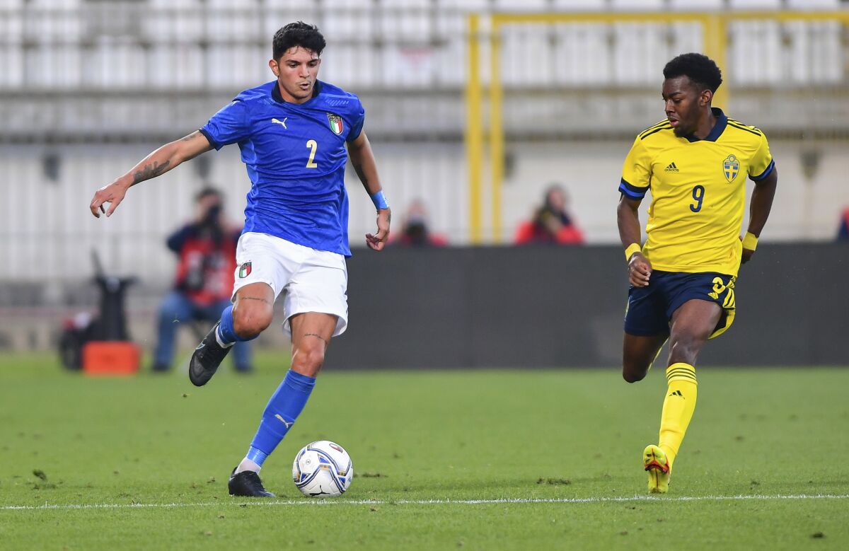 Italy's Raoul Bellanova, left, and Sweden's Anthony Elanga in action during their under 21 European Championship qualifying soccer match in Monza, Italy, Tuesday, Oct. 12, 2021. A player on Sweden's under-21 national soccer team has claimed he was racially abused by an opponent in a European Championship qualifying match against Italy. Anthony Elanga, a striker who plays at Manchester United, said he was subjected to a racist comment in Tuesday's match in Monza, the Swedish soccer association said Wednesday. (Claudio Grassi/LaPresse via AP)