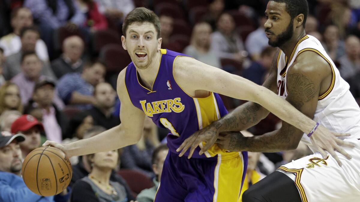 Ryan Kelly tries to drive past Cleveland's Earl Clark during a game in February. Kelly averaged 8.0 points and 3.7 rebounds with the Lakers last season.