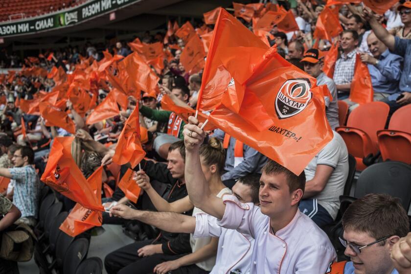 Fans of the Donetsk Shakhtar soccer club ,owned by Ukrainian magnate Rinat Akhmetov, wave flags at one of the rallies that began Tuesday in defiance of armed pro-Russia militants occupying more than a dozen towns and cities in eastern Ukraine.