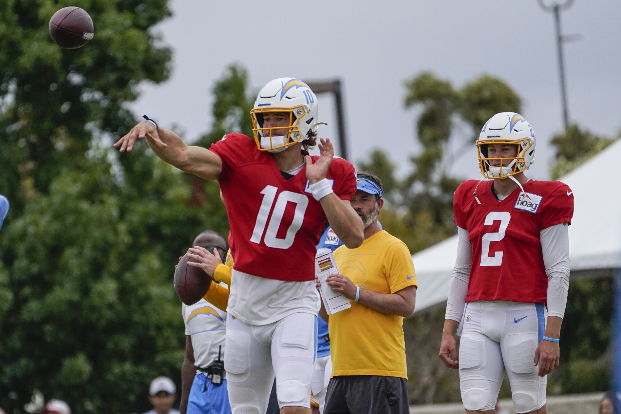 Chargers quarterbacks, Justin Herbert, left, and Easton Stick warm up for their Friday joint practice  with the 49ers.