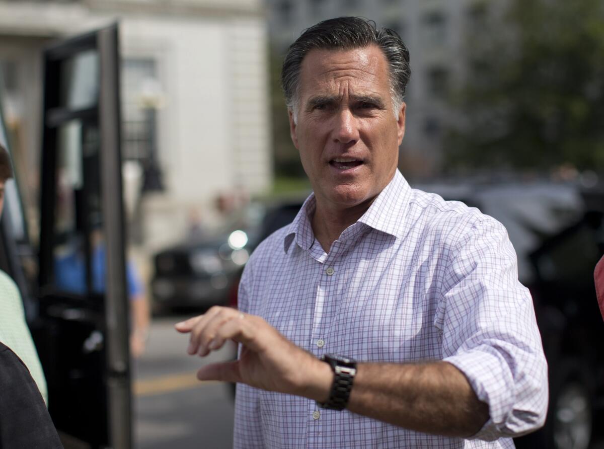 Mitt Romney speaks with the news media after visiting with veterans in Concord, N.H.