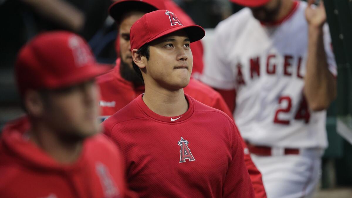 Los Angeles Angels designated hitter Shohei Ohtani walks through the dugout before Monday's game against the Milwaukee Brewers.