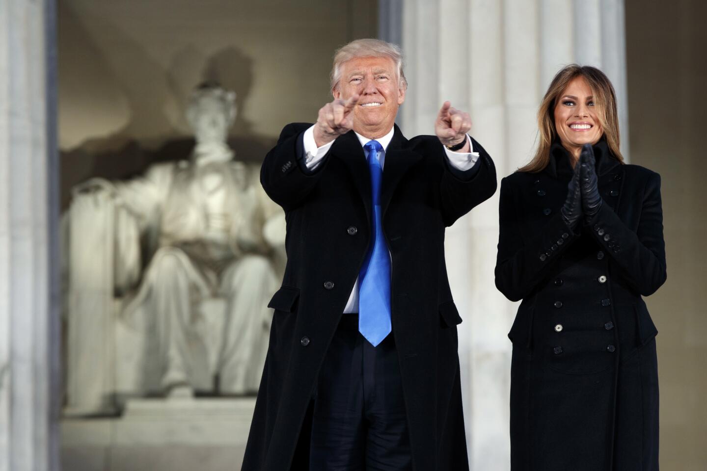 President-elect Donald Trump, left, and his wife Melania Trump arrive to the "Make America Great Again Welcome Concert" at the Lincoln Memorial, Thursday, Jan. 19 in Washington.