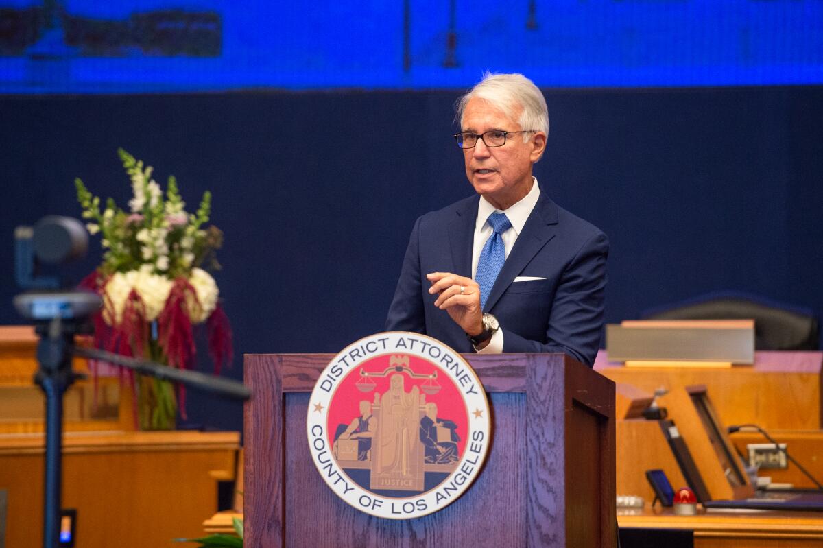 Los Angeles County Dist. Atty. George Gascón delivers remarks at a lectern 