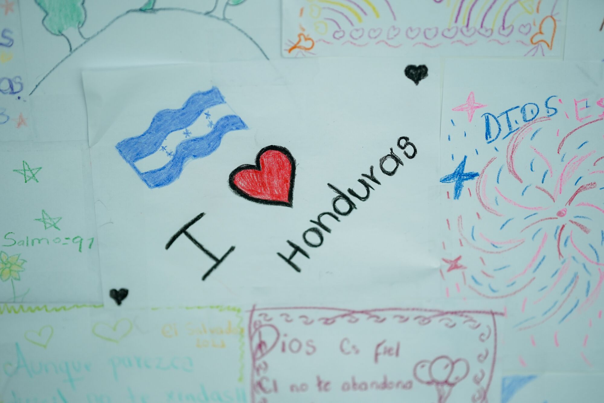 A child's drawing of the Honduran flag with the phrase I heart Honduras beneath it