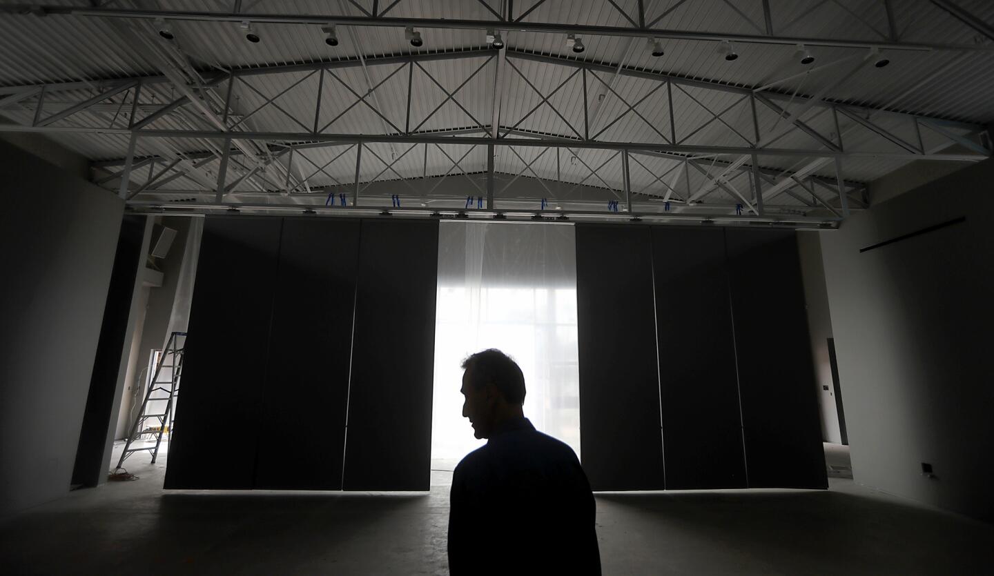 Curator Joes Segal looks around the Wende Museum's new location at the former National Guard Armory along Culver Boulevard in Culver City.