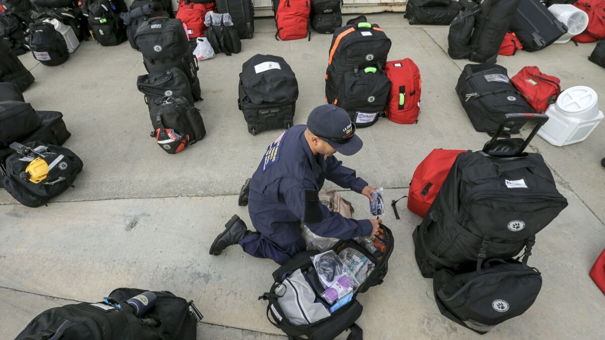 Daniel Altruz, 45, of the Los Angeles County Urban Search and Rescue team prepares for deployment to Mexico or Puerto Rico to assist in emergency aid efforts on Wednesday in Pacoima.