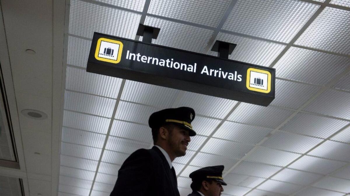 A Saudia Airlines crew arrives at the international arrivals hall at Washington Dulles International Airport.