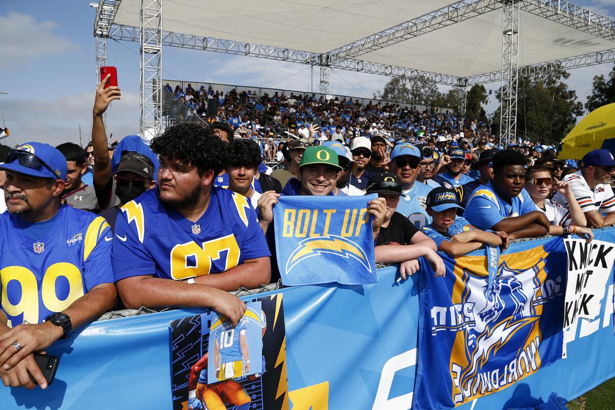 A fan shows off his Chargers "Bolt Up" towel during the first day of training camp at Jack Hammett Sports Complex.