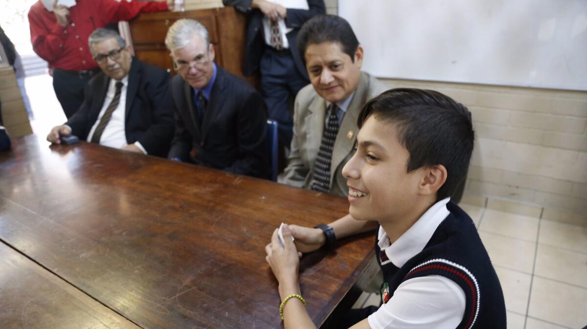 Tijuana sixth grader Angel Isaac, 12, was born in Fontana and studied on both sides of the border. Listening are Tom Torlakson, California's State Superintendent of Public Instruction, seated at center, and Baja California Education Secretary Miguel Angel Mendoza seated at right.