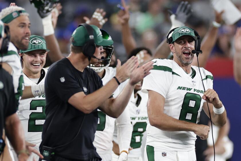New York Jets quarterback Aaron Rodgers (8) reacts to a touchdown during the second half of an NFL preseason football game against the New York Giants, Saturday, Aug. 26, 2023, in East Rutherford, N.J. (AP Photo/Adam Hunger)