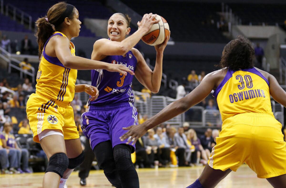 Mercury guard Diana Taurasi drives to the basket against Sparks guard Lindsey Harding and forward Nneka Ogwumike in the first half Thursday night.