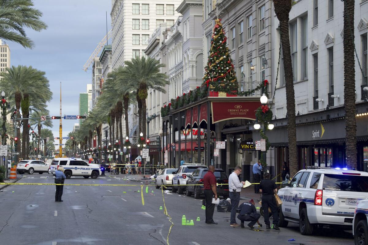 New Orleans police investigate the scene of a shooting Sunday at the edge of the French Quarter.