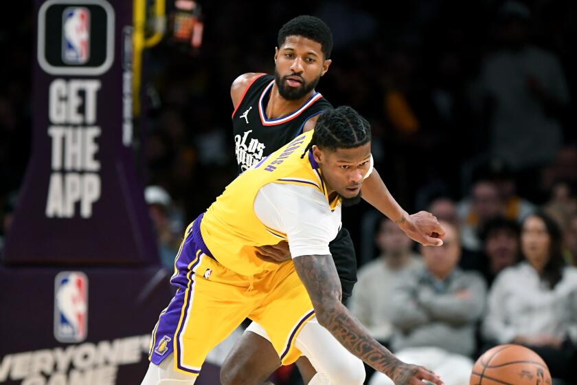 Lakers Cam Reddish steals the ball away from Clippers Paul George at Crypto.com Wednesday. (Wally Skalij/Los Angeles Times)