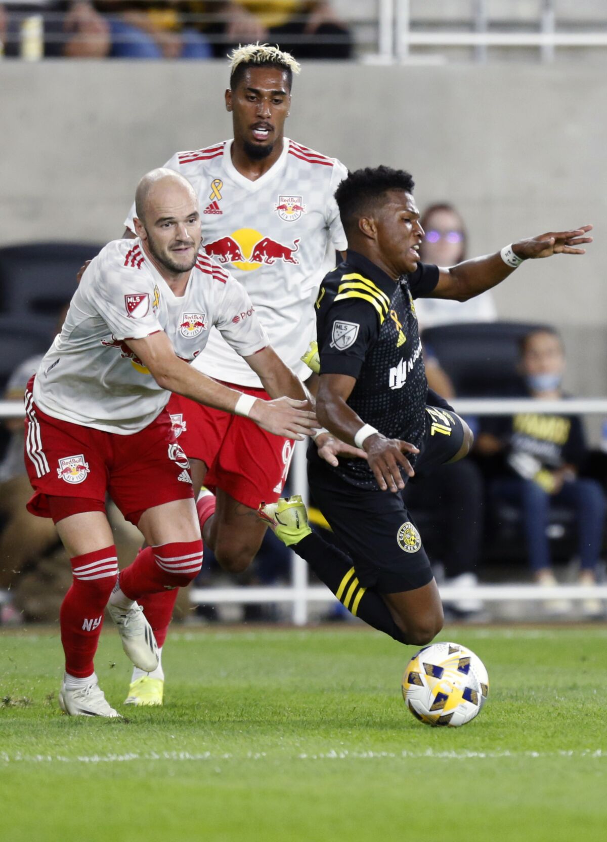 New York Red Bulls defender Andrew Gutman left, and forward Fabio work for the ball behind Columbus Crew midfielder Luis Diaz during the second half of an MLS soccer match in Columbus, Ohio, Tuesday, Sept. 14, 2021. The Crew won 2-1. (AP Photo/Paul Vernon)