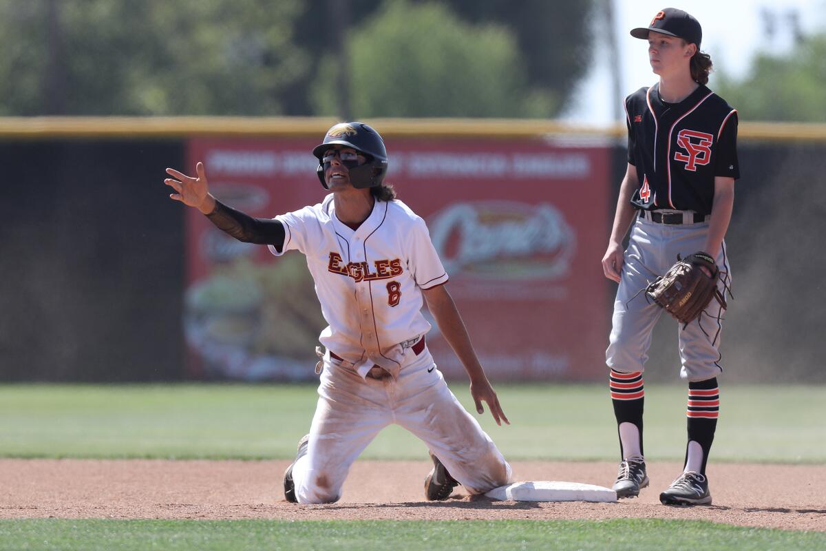 Estancia's Jack Moyer, left, disagrees with being tagged during the first inning against Santa Ynez on Tuesday.