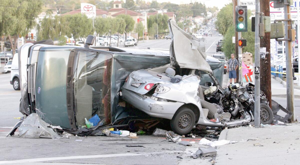 Glendale police forensics officer photographs the scene of a crash where a green van heading south on New York Ave. ran a red light crashing into the silver car heading west on Foothill Blvd. The driver and occupant of the silver car were air lifted to USC hospital in critical condition. Driver of the van had minor injuries.