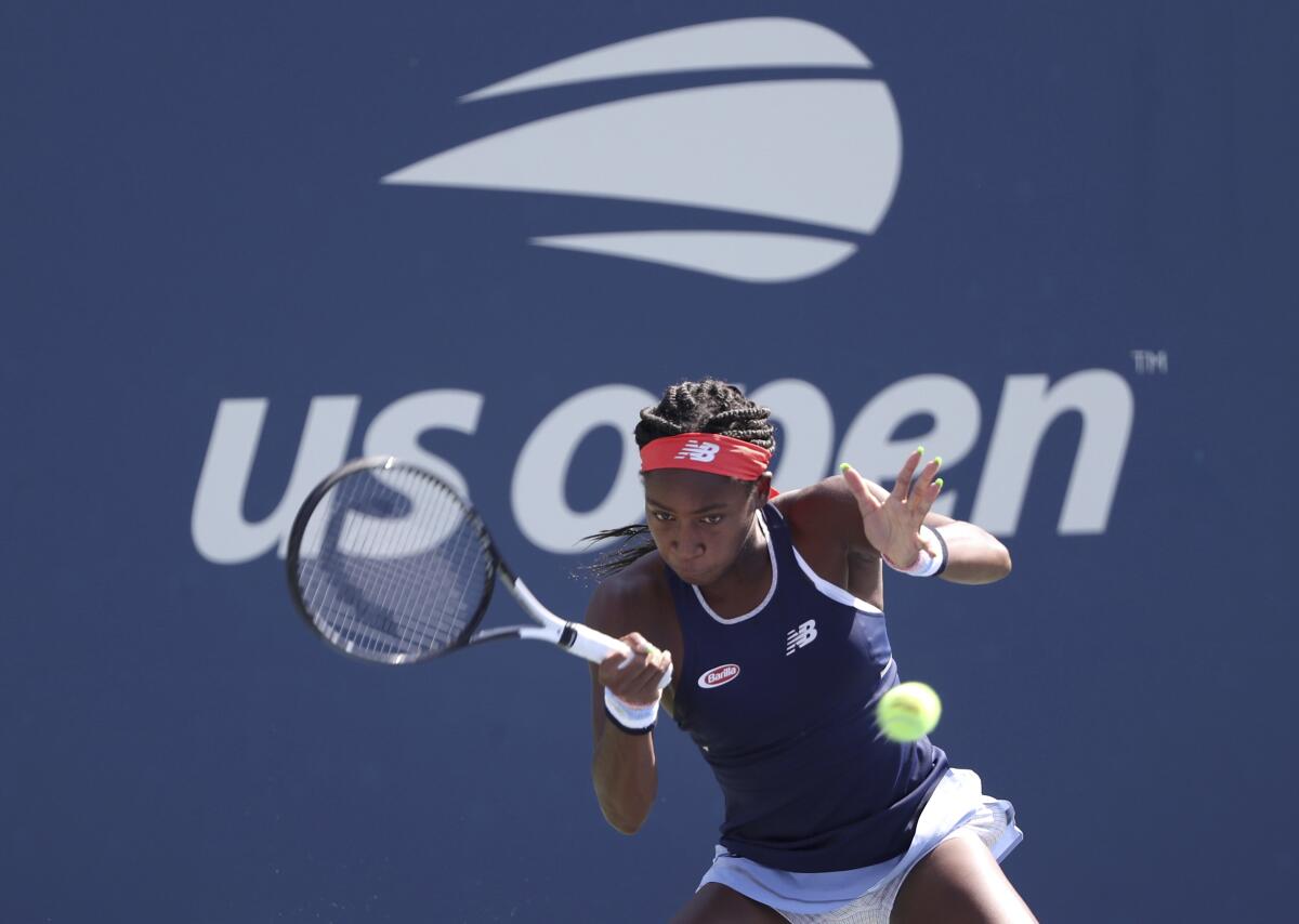 Coco Gauff returns a shot during a doubles match on Friday at the U.S. Open.