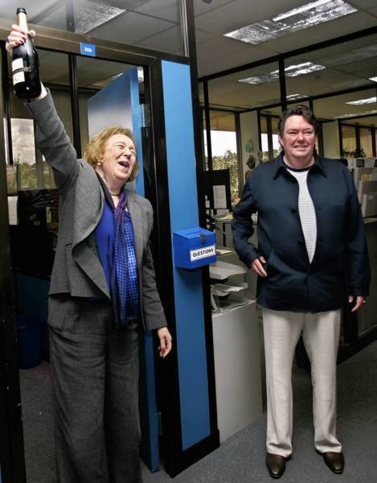 San Diego Union-Tribune publisher David Copley, right, and editor Karin Winner celebrate the newspaper’s 2006 Pulitzer Prize for national reporting.