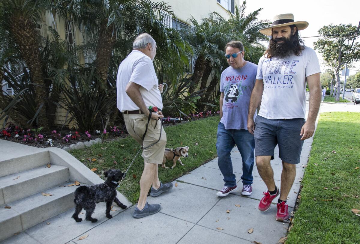 Sam Pocker. center, first hired a people walker out of morbid curiosity. Now he books at least one appointment a day.