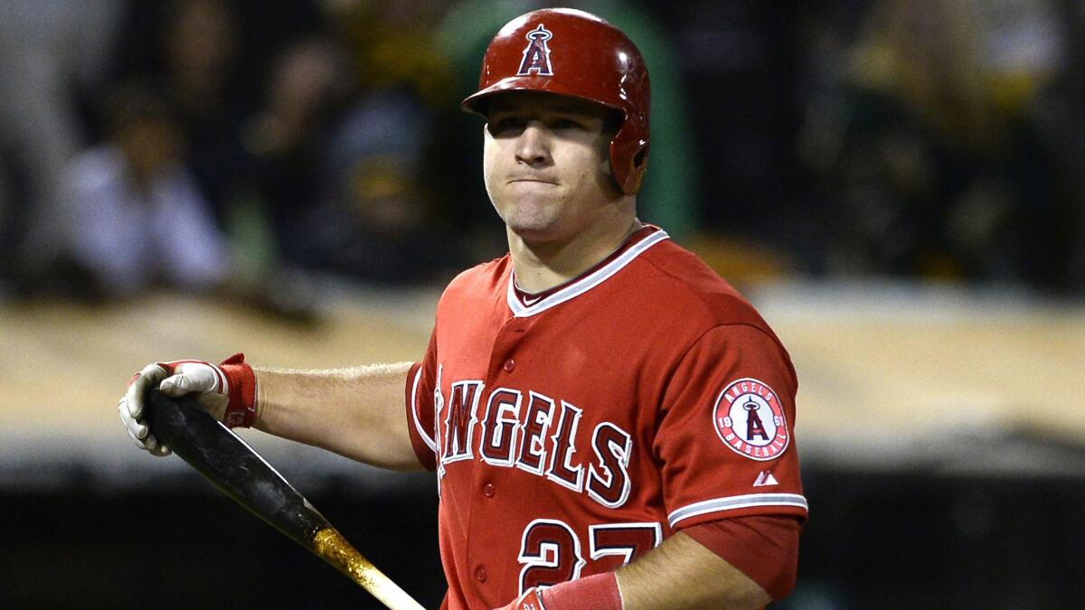 Angels outfielder Mike Trout grimaces after striking out against the Oakland Athletics on Friday. Back discomfort forced Trout to leave in the first inning of Tuesday's game against the Houston Astros