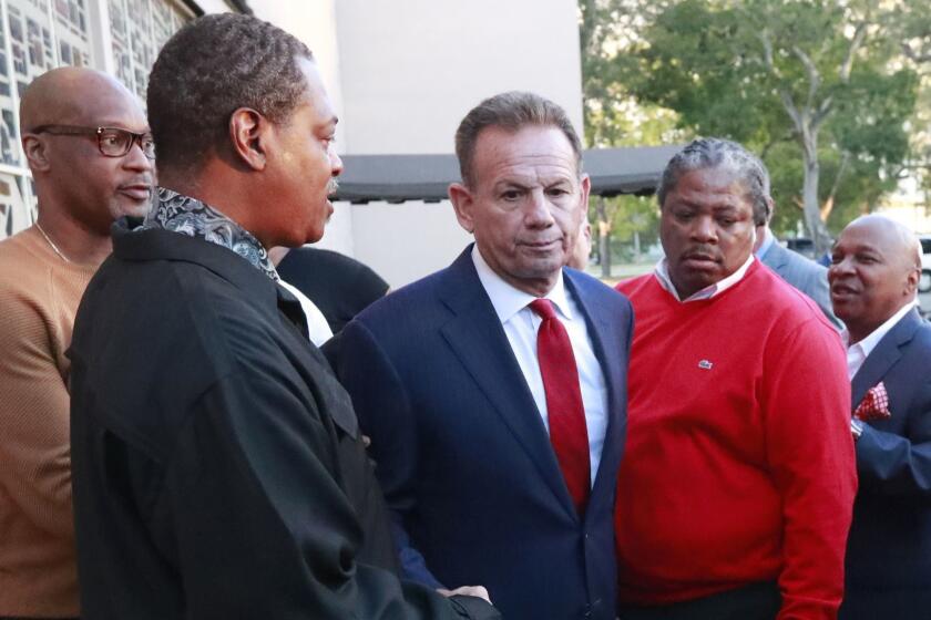 FILE- In this Jan. 11, 2019 file photos suspended Broward County Sheriff Scott Israel, center, leaves a news conference surrounded by supporters after new Florida Gov. Ron DeSantis suspended him, in Fort Lauderdale, Fla. The Florida Supreme Court has ruled against a sheriff who fought his removal from office after the governor claimed he failed to prevent last year's Parkland school shooting. Florida's highest court agreed Tuesday, April 23, 2019, that Gov. Ron DeSantis was within his authority to suspend Israel as Broward County sheriff earlier this year. The justices noted that under the Florida Constitution, the state Senate is responsible for deciding whether the removal should be permanent. (AP Photo/Wilfredo Lee)