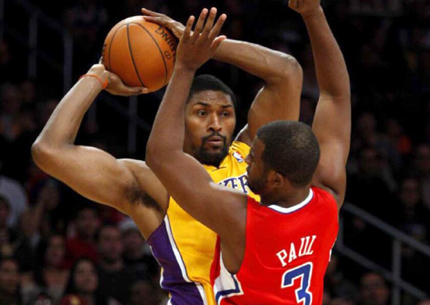 Lakers forward Metta World Peace grabs a rebound and looks to pass against Clippers point guard Chris Paul during a game last season.