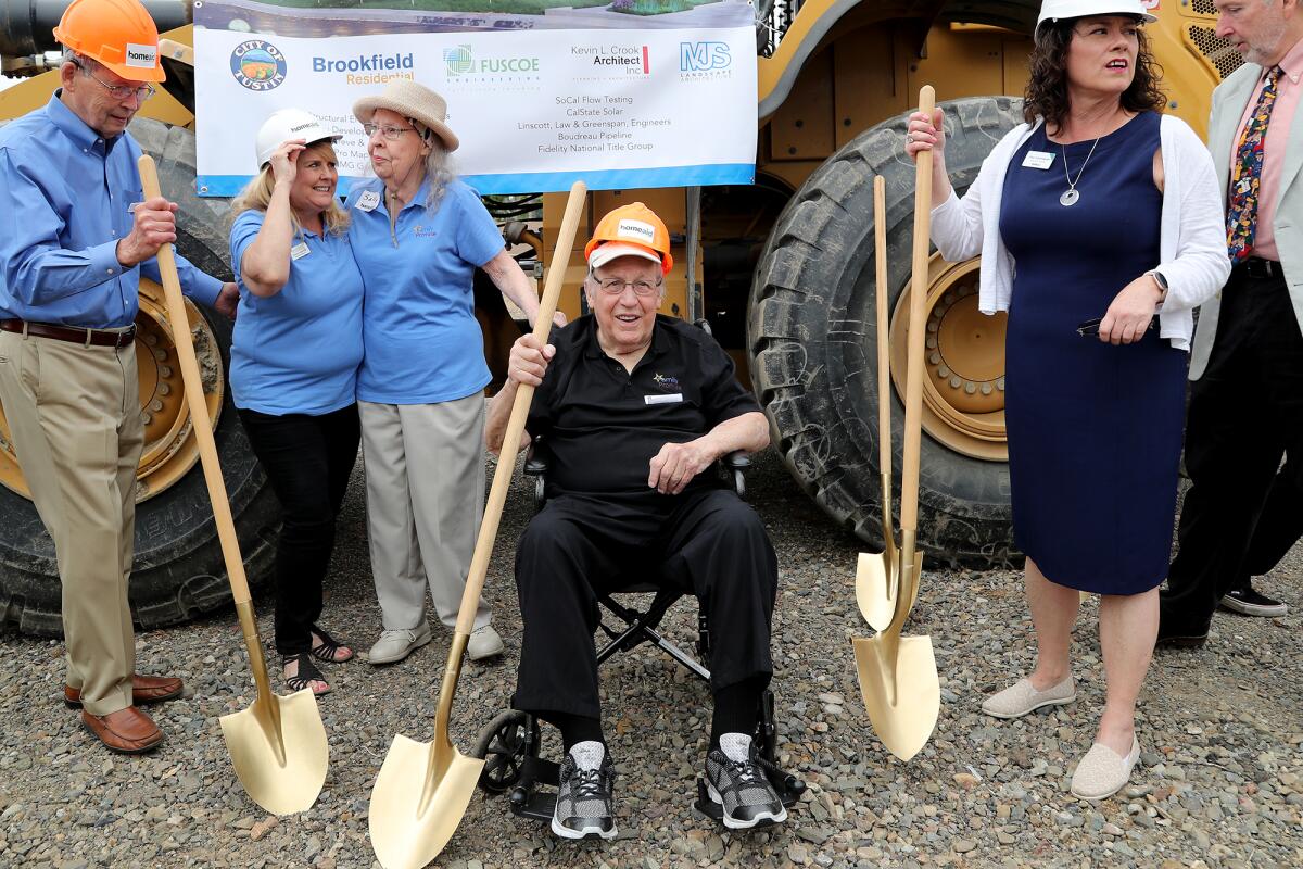 Bernie Jeltema, center, and his wife Sally, third from left, at the groundbreaking for House of Ruth.