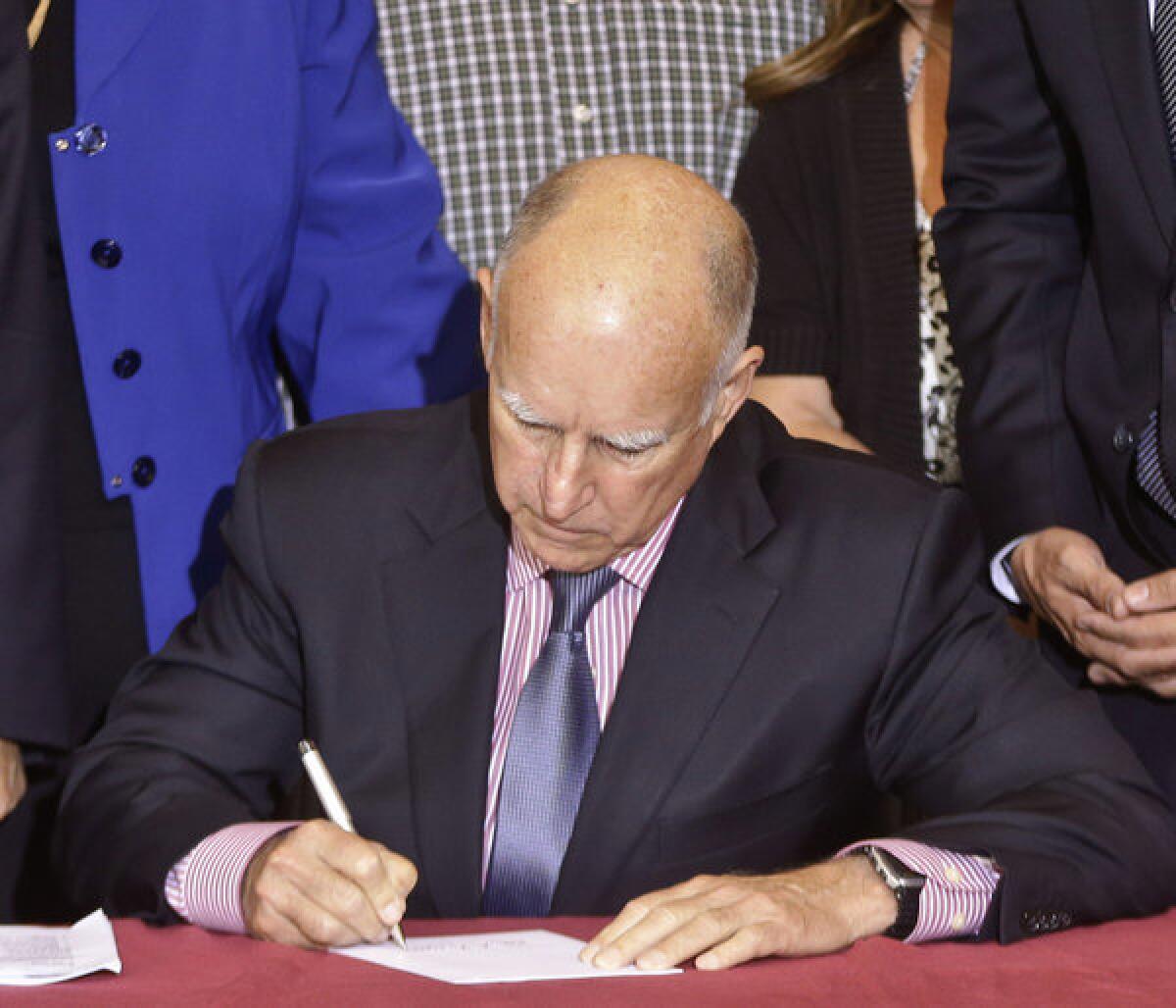 California Gov. Jerry Brown signs legislation into law Thursday. Under one bill, state community colleges will now be able to charge more for high-demand classes during summer and winter terms.