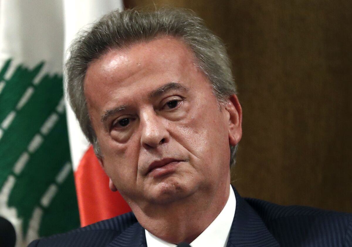 FILE - Riad Salameh the governor of Lebanon's Central Bank, listens to a journalist's question during a press conference, in Beirut, Lebanon, Nov. 11, 2019. A Lebanese judge issued Tuesday, Jan. 11, 2022, a travel ban for the country's central bank governor following a local corruption lawsuit accusing him of embezzlement and dereliction of duties in the country's ongoing financial meltdown, state-run National News Agency reported. (AP Photo/Hussein Malla, File)