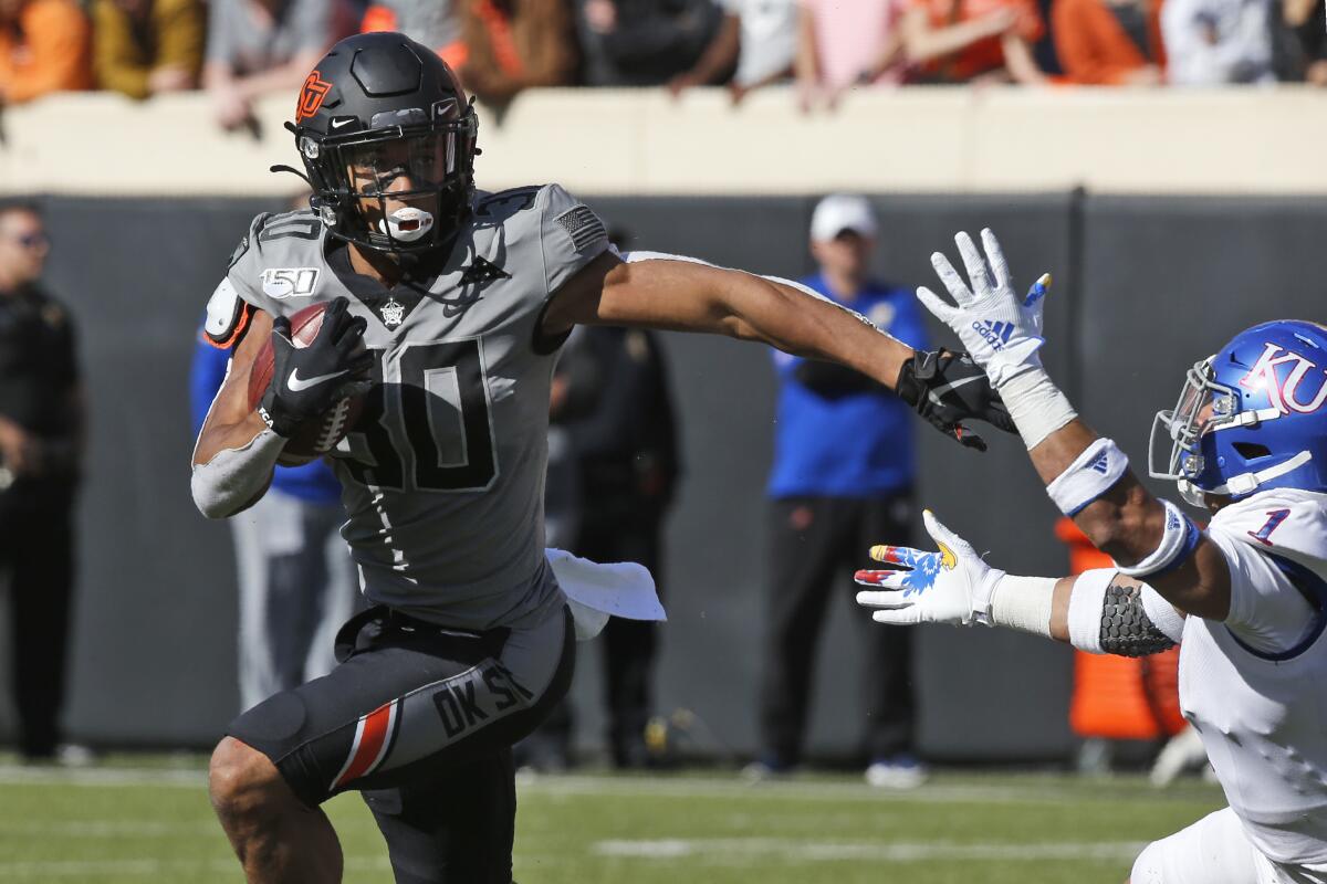 Oklahoma State running back Chuba Hubbard gets past Kansas safety Bryce Torneden on Nov. 16, 2019.