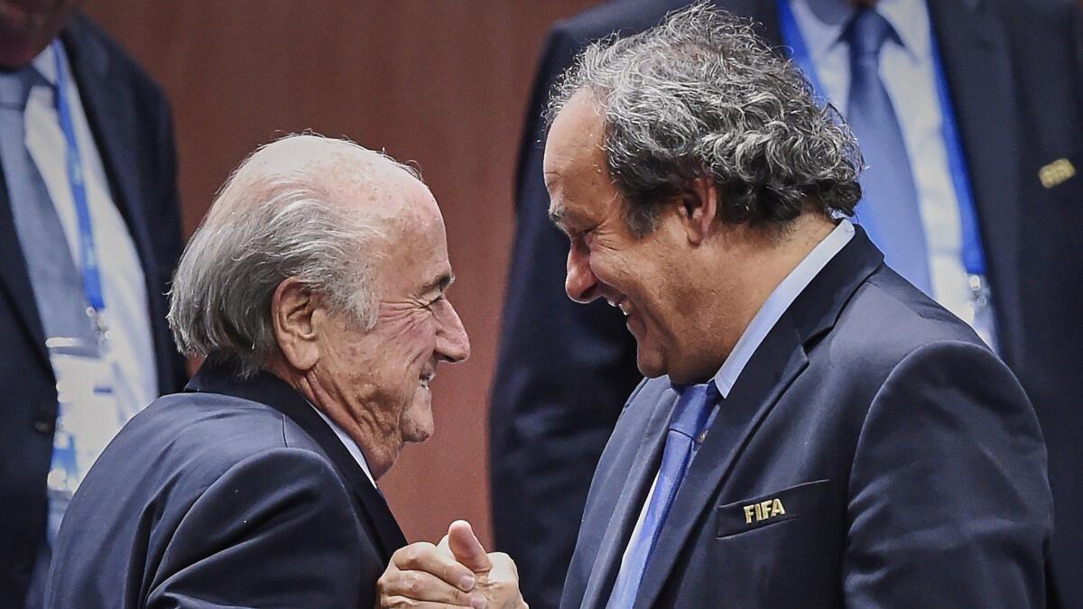 FIFA President Sepp Blatter (Foreground-L) shakes hands with UEFA president Michel Platini after being re-elected following a vote to decide on the FIFA presidency in Zurich on May 29, 2015. Sepp Blatter won the FIFA presidency for a fifth time after his challenger Prince Ali bin al Hussein withdrew just before a scheduled second round. AFP PHOTO / MICHAEL BUHOLZERMICHAEL BUHOLZER/AFP/Getty Images ** OUTS - ELSENT, FPG - OUTS * NM, PH, VA if sourced by CT, LA or MoD **