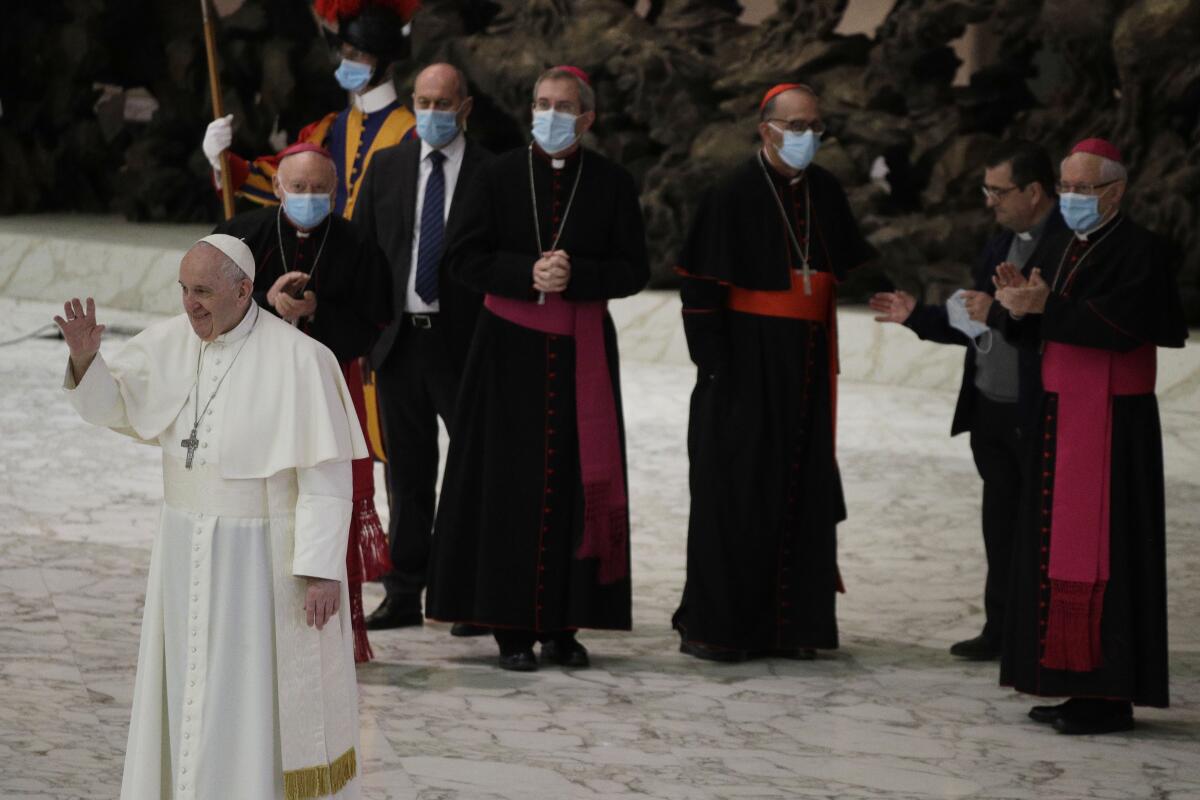 Pope Francis waves at the end of the weekly general audience in the Paul VI hall at the Vatican