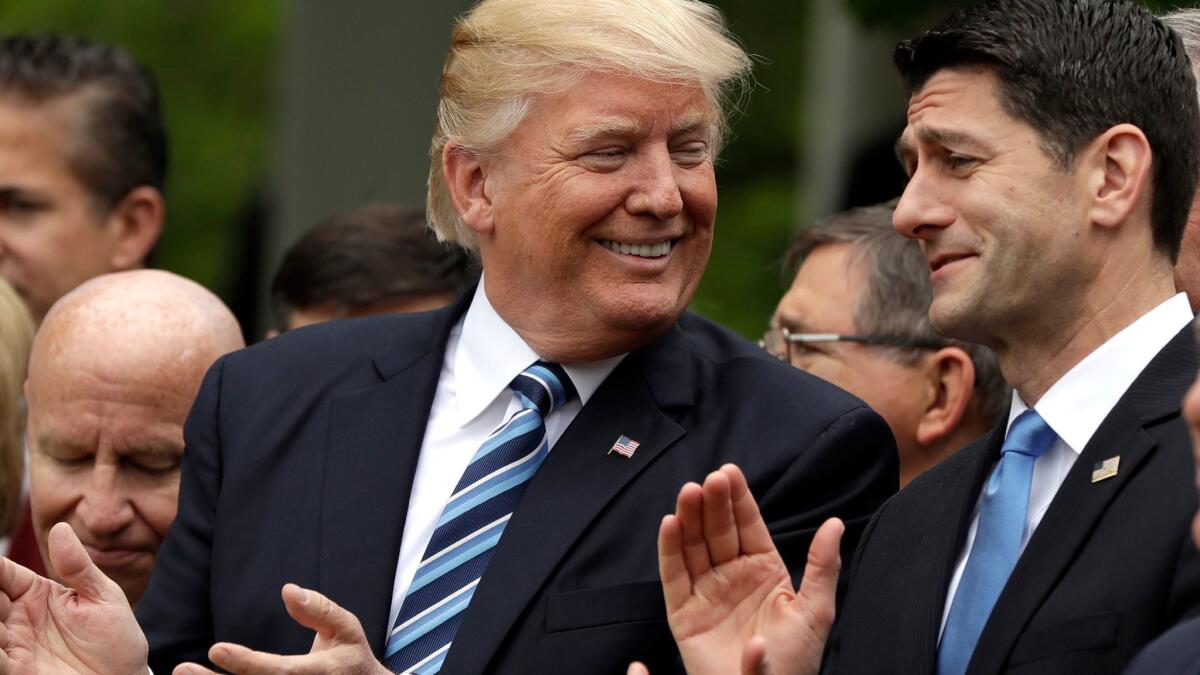 President Trump talks to House Speaker Paul Ryan on May 4 in the Rose Garden of the White House after the House pushed through the American Health Care Act.