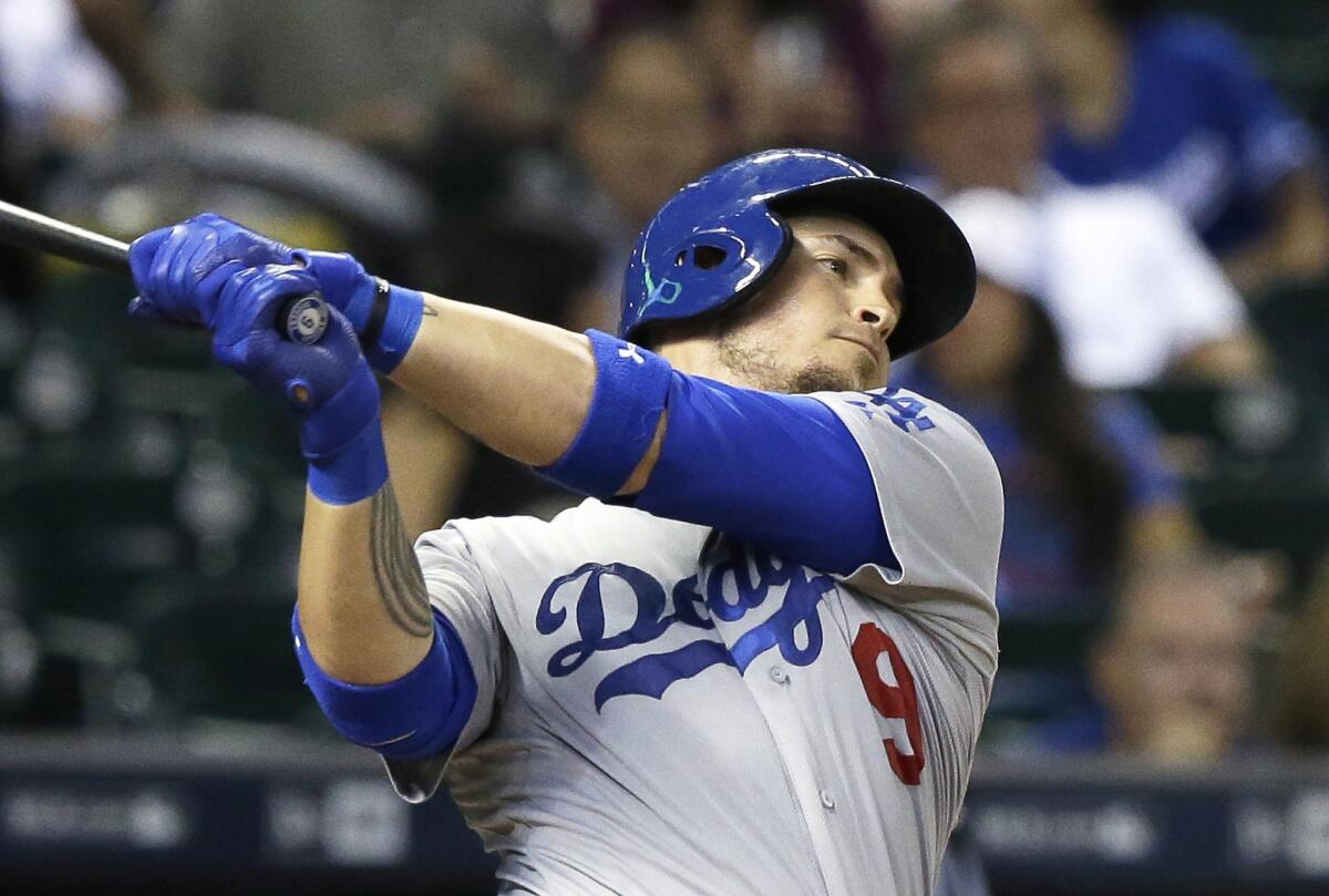 Dodgers catcher Yasmani Grandal swings and misses a pitch against the Astros on Aug. 21.