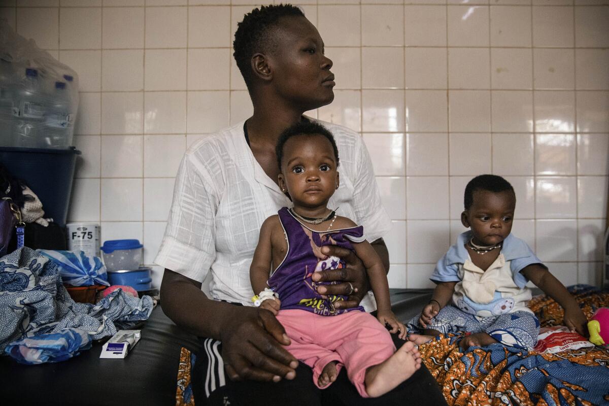 Malnourished children wait for treatment in a hospital in Burkina Faso.