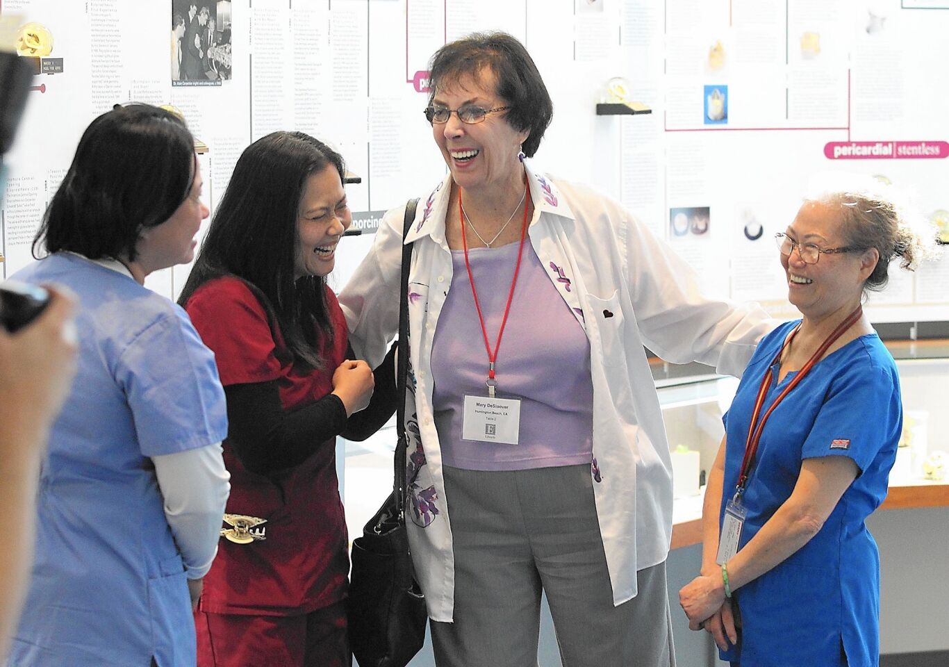 Heart patient Mary DeSloover, center, of Huntington Beach, thanks part of her surgical team during Edward Lifesciences Patient Day on Friday in Irvine.