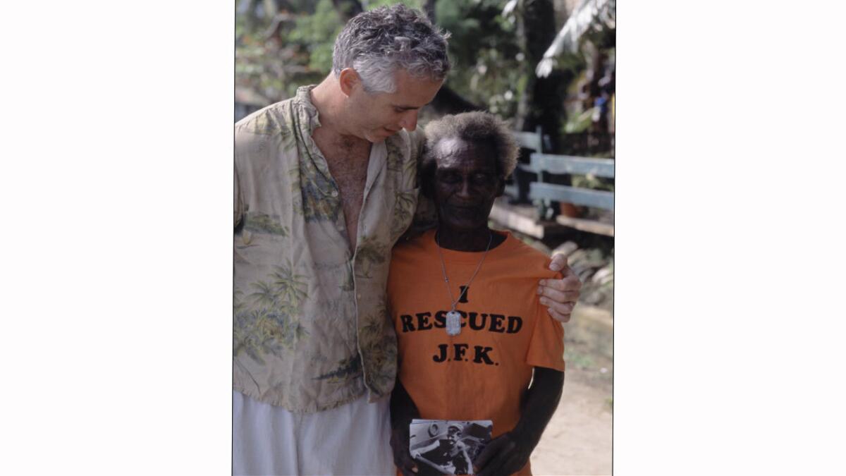 Max Kennedy, nephew of President Kennedy, visits Eroni Kumana, right, in November 2002 in the Solomon Islands.