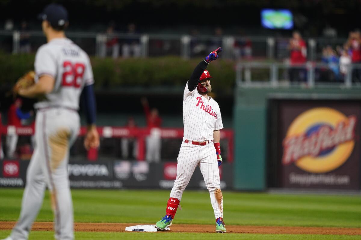 The Phillies' Bryce Harper reacts after he hit an RBI double during the seventh inning Oct. 14, 2022.