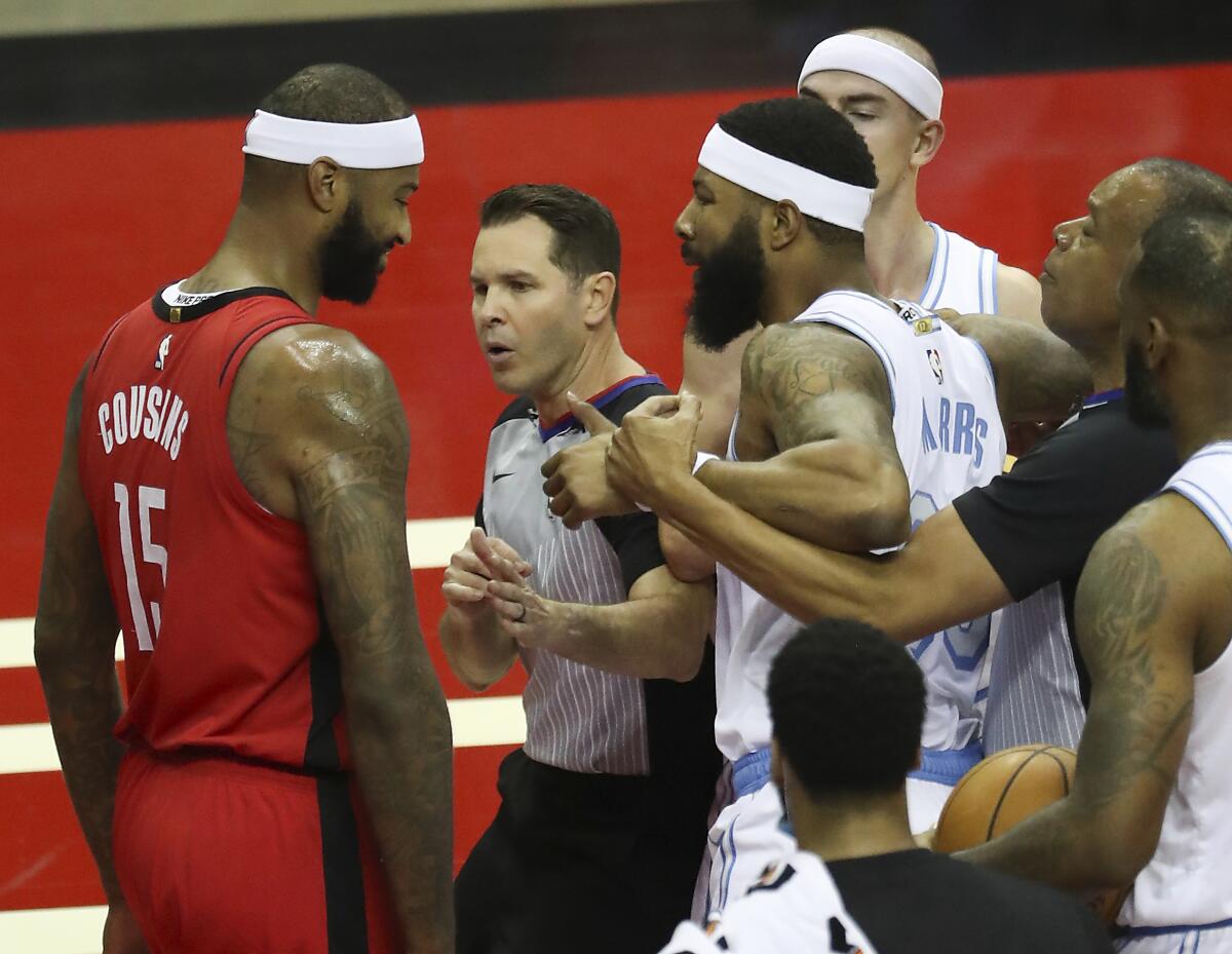 Lakers forward Markieff Morris, right, gets into an altercation with Rockets center DeMarcus Cousins.